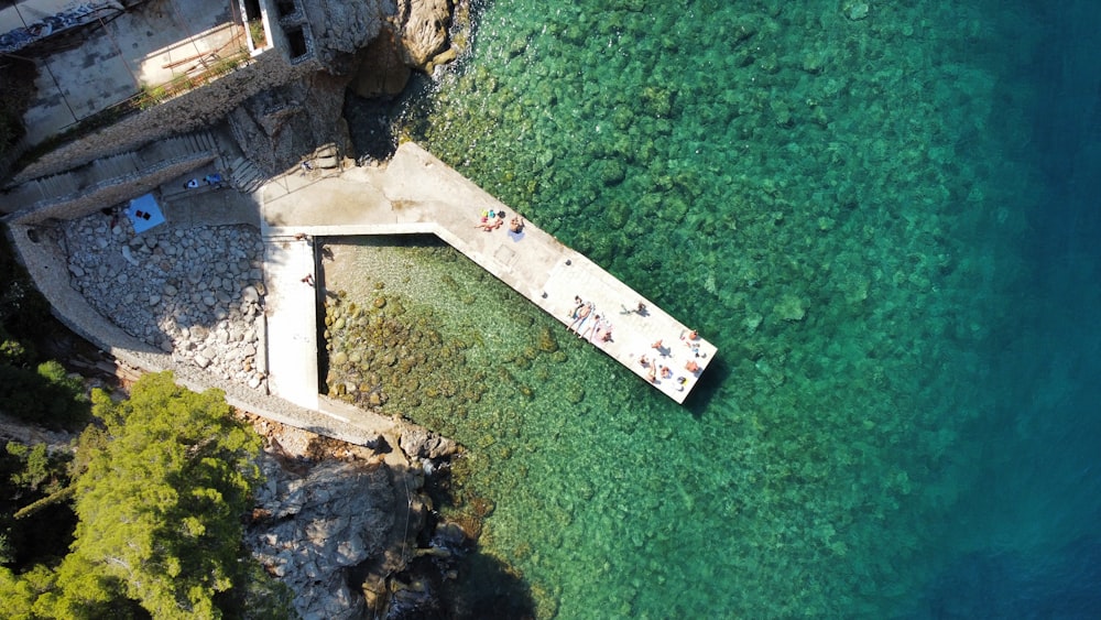 an aerial view of a pier and a body of water