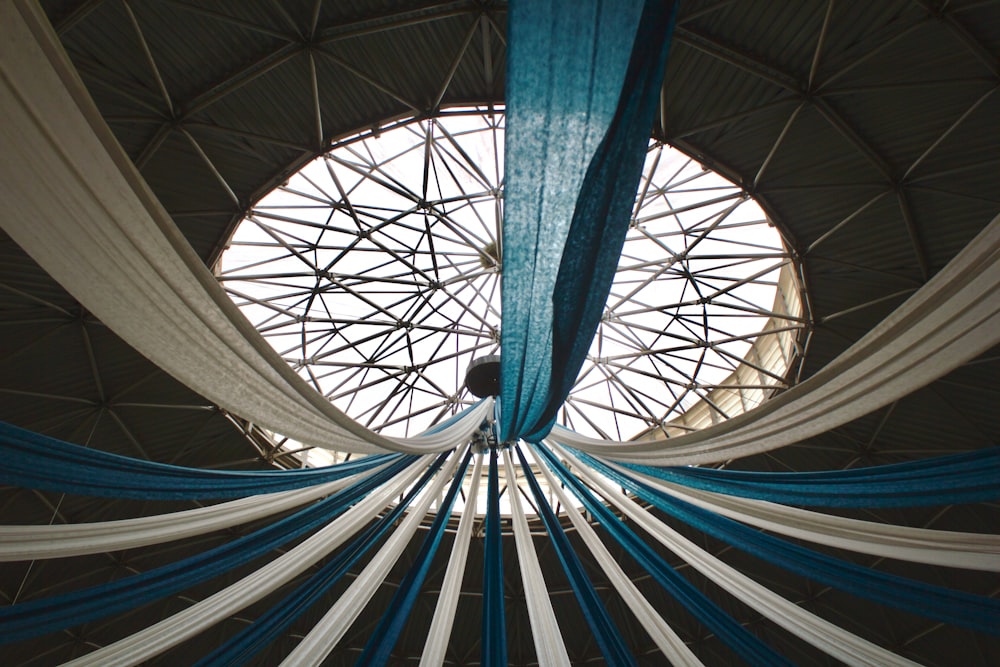 a view of a ceiling with white and blue draping