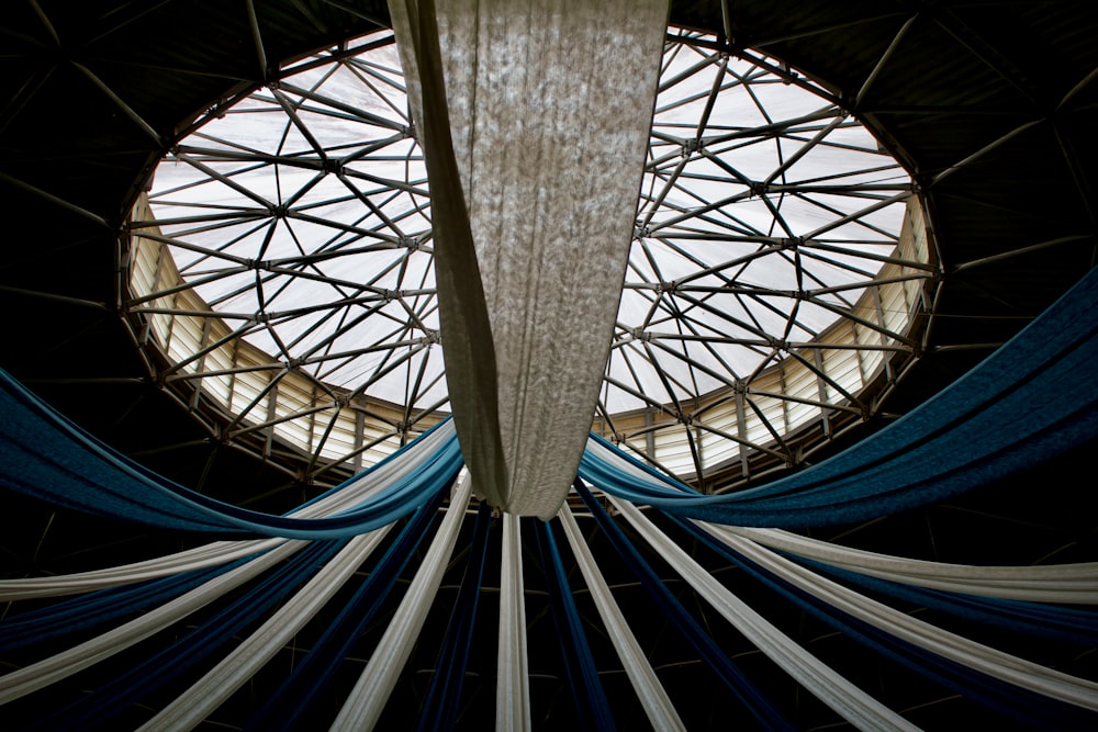 a large round window with blue and white curtains