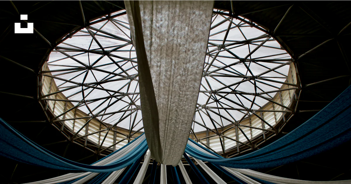 A large round window with blue and white curtains photo – Free Ceeling ...