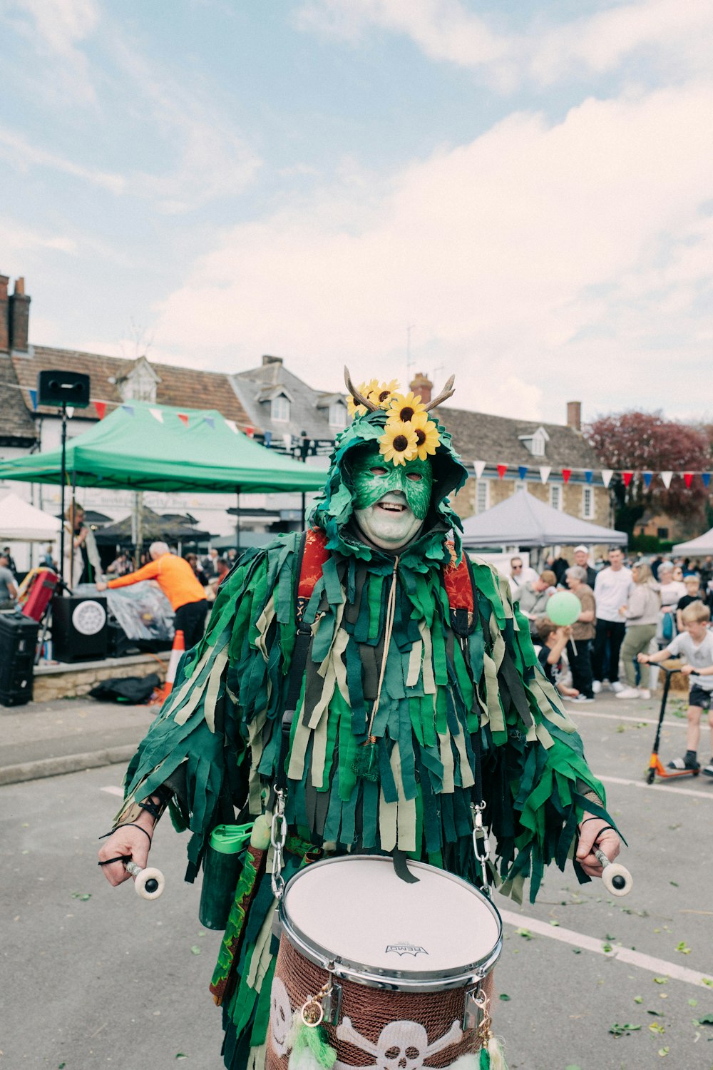 a man in a costume is playing a drum