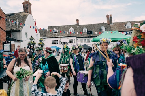 A vibrant street scene in Riverside with British flags hanging from lamp posts during a local UK-themed festival.
