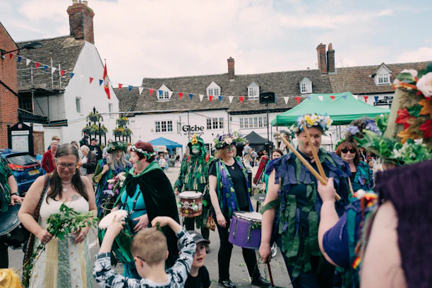 A lively street scene during the Boundary Road Festival with colorful stalls and smiling visitors.