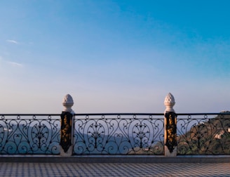 Intricate railings on a balcony overlooking a scenic view.