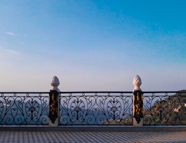 Intricate railings on a balcony overlooking a scenic view.