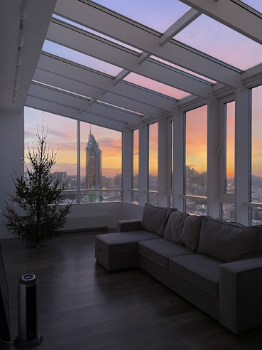 Sunlit living room of a modern Dubai apartment with floor-to-ceiling windows and plush seating.