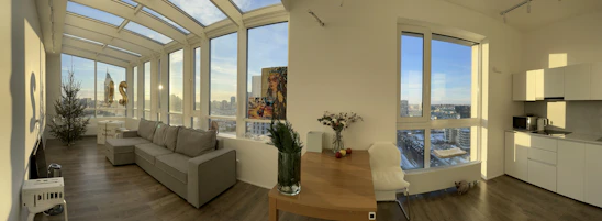 A cozy, modern corporate rental apartment with stylish furnishings and a bright city view.