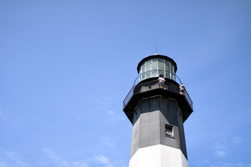 a light house with a blue sky in the background