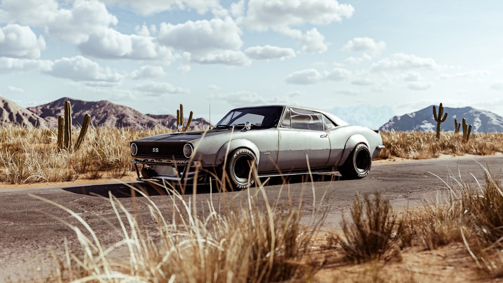 a car driving down a road in the desert