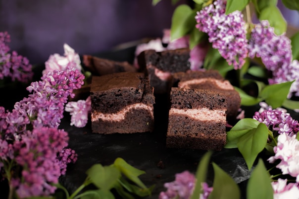 a close up of a plate of brownies and flowers