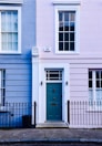 a blue and pink building with a blue door