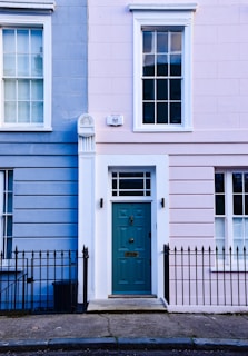 a blue and pink building with a blue door