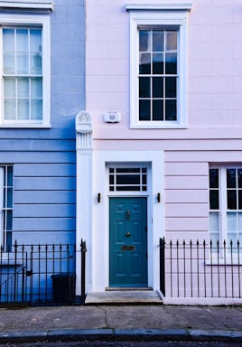 a blue and pink building with a blue door