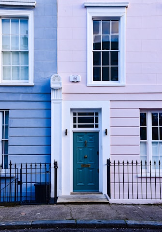 a blue and pink building with a blue door