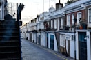 a row of houses on a cobblestone street