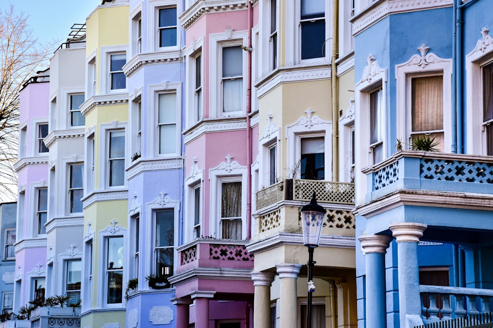 a row of multicolored buildings with a clock on the top