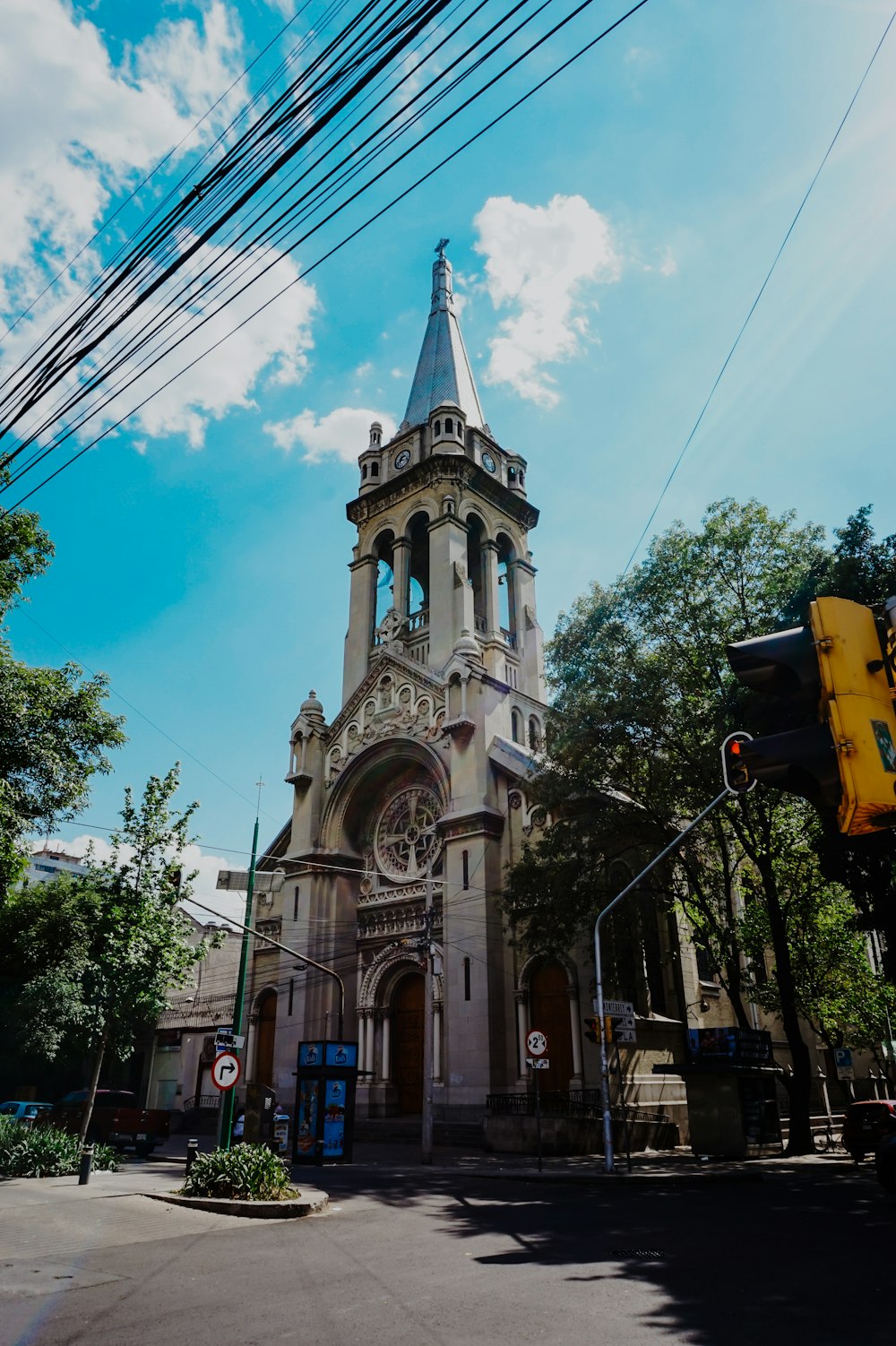 a large church with a tall steeple on a sunny day