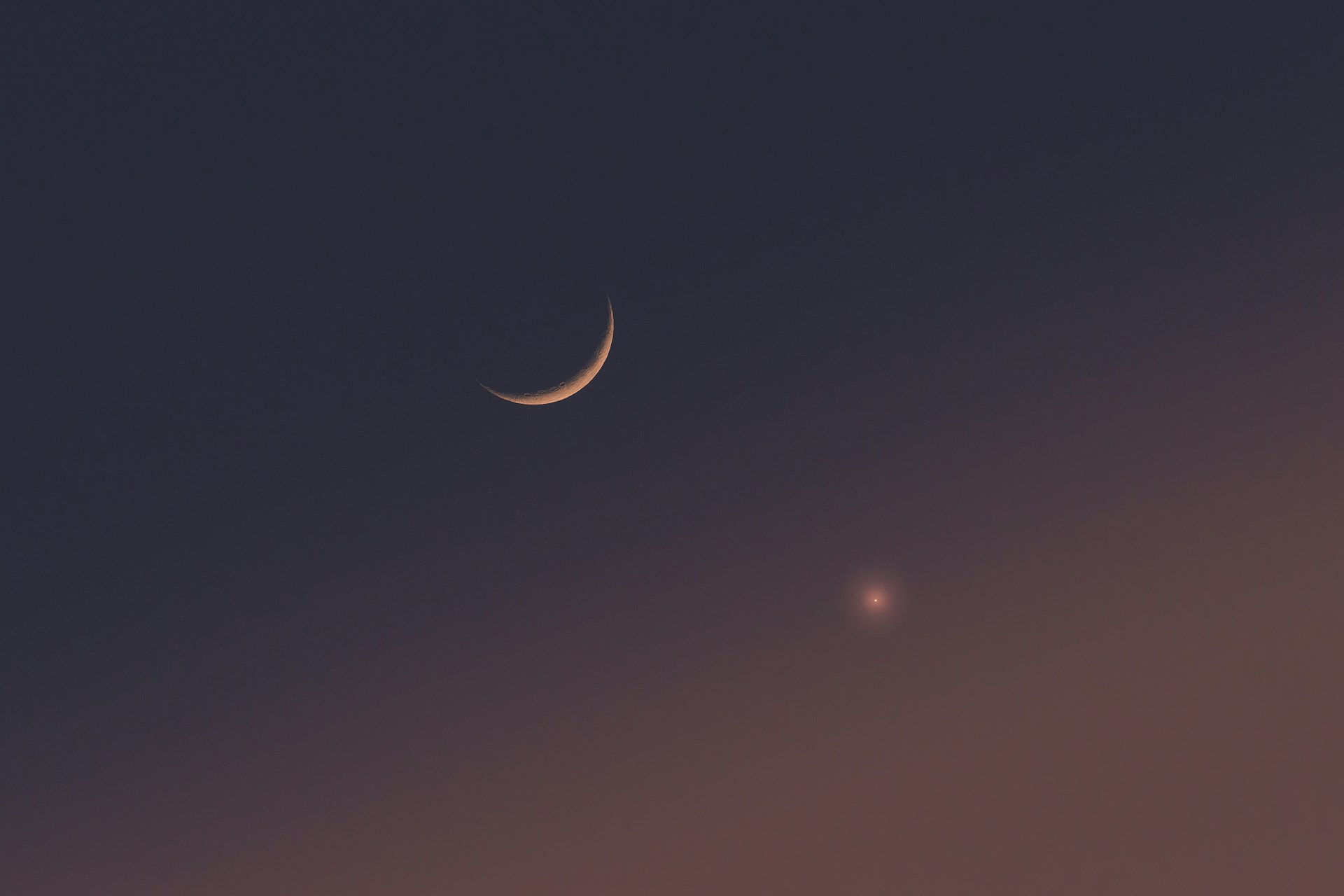 two crescents are seen in the night sky