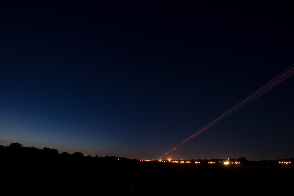 an airplane is flying in the sky at night