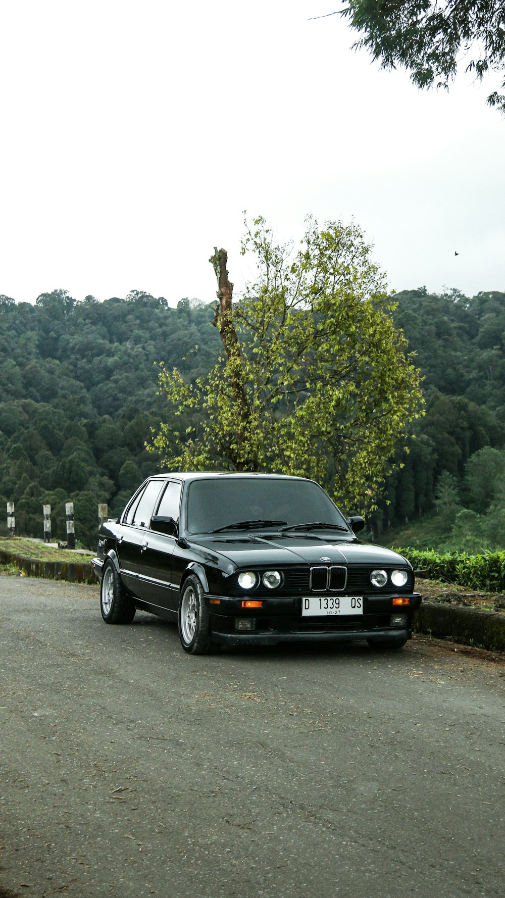 a black car parked on the side of a road