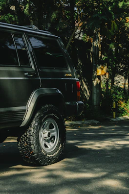 A large SUV parked in a driveway, representing bigger vehicles we take.