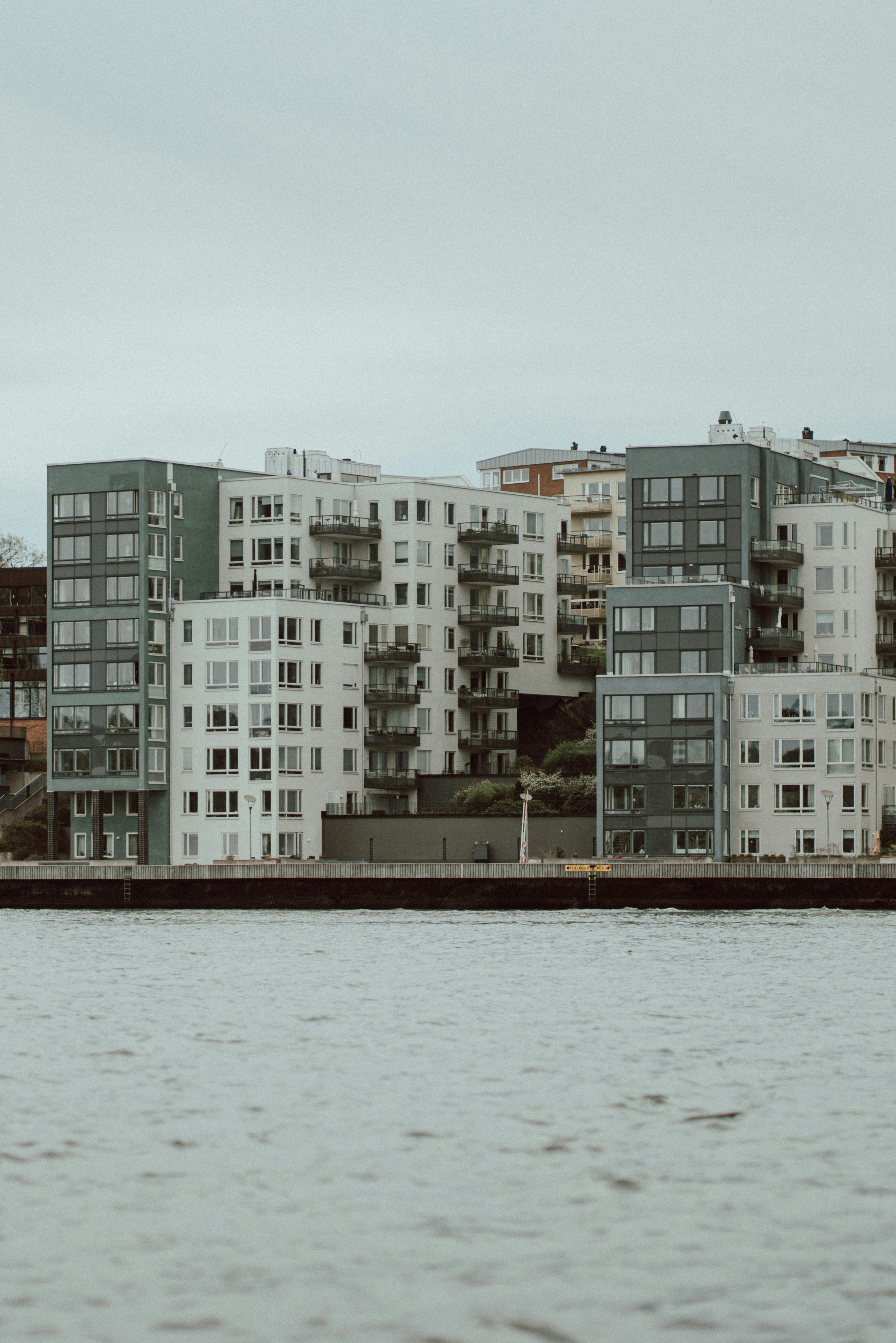 a large body of water with buildings in the background