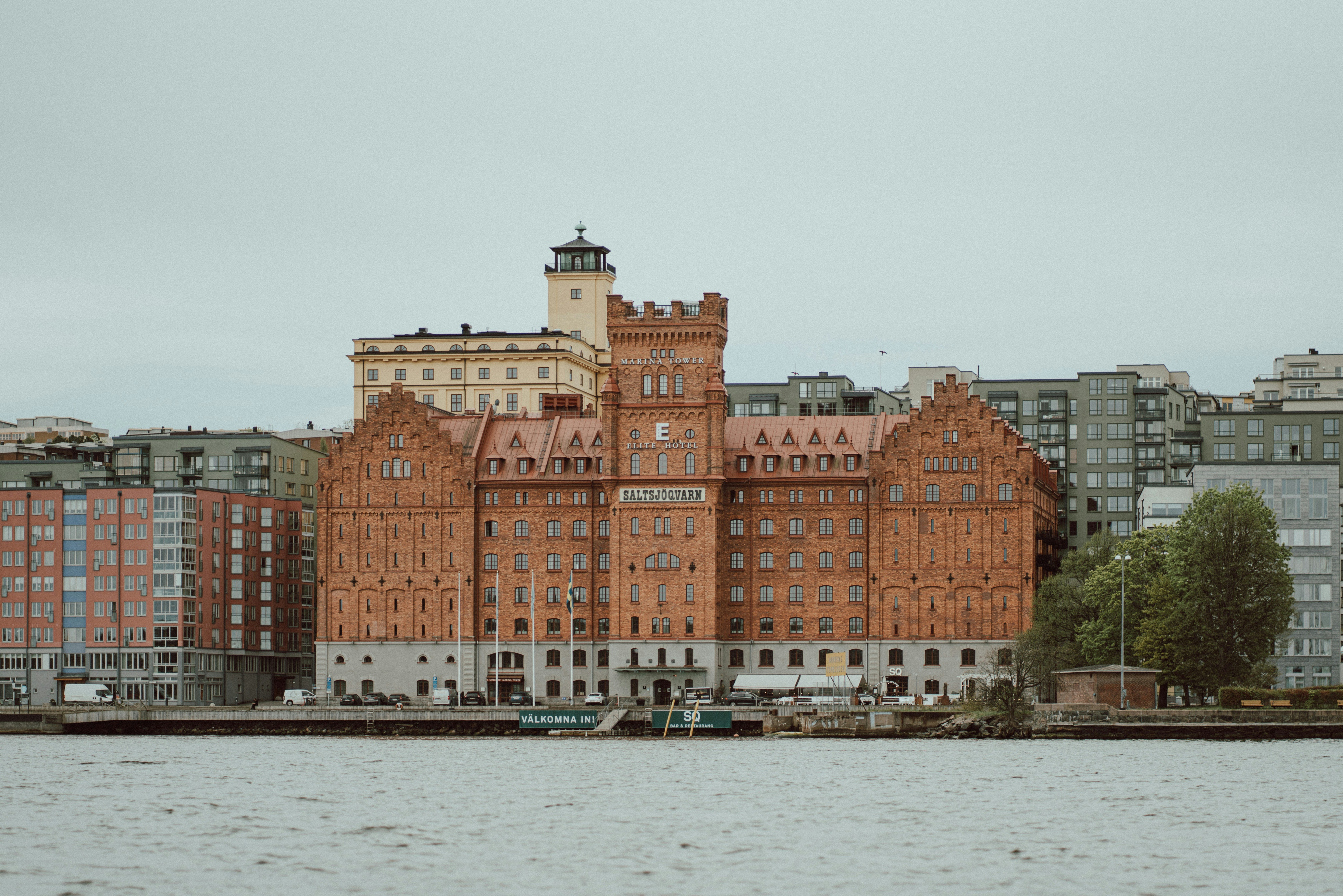 a large building sitting on the side of a river