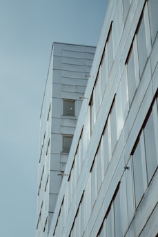 A sleek modern building under construction with clean lines and premium materials.