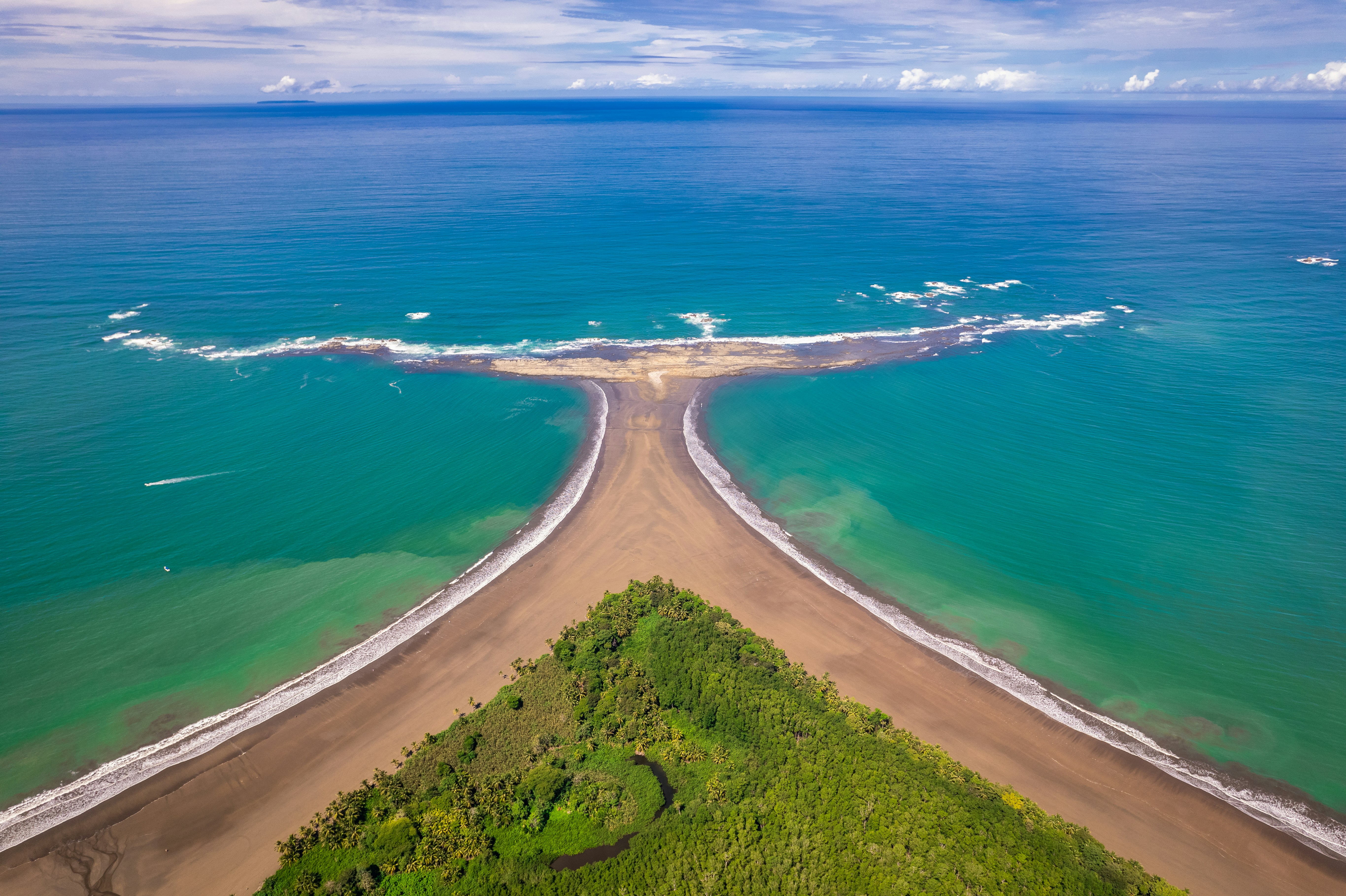 an aerial view of a beach and ocean, Aerial View of Whale Tail Peninsula, Costa Rica - Whale Tail Peninsula is a natural wonder of Costa Rica. The peninsula is shaped like a whale tail, and it is located in the beautiful Ballena Bay. The peninsula is a great place to go swimming, sunbathing, or hiking. It is also a great place to see whales and other marine life.