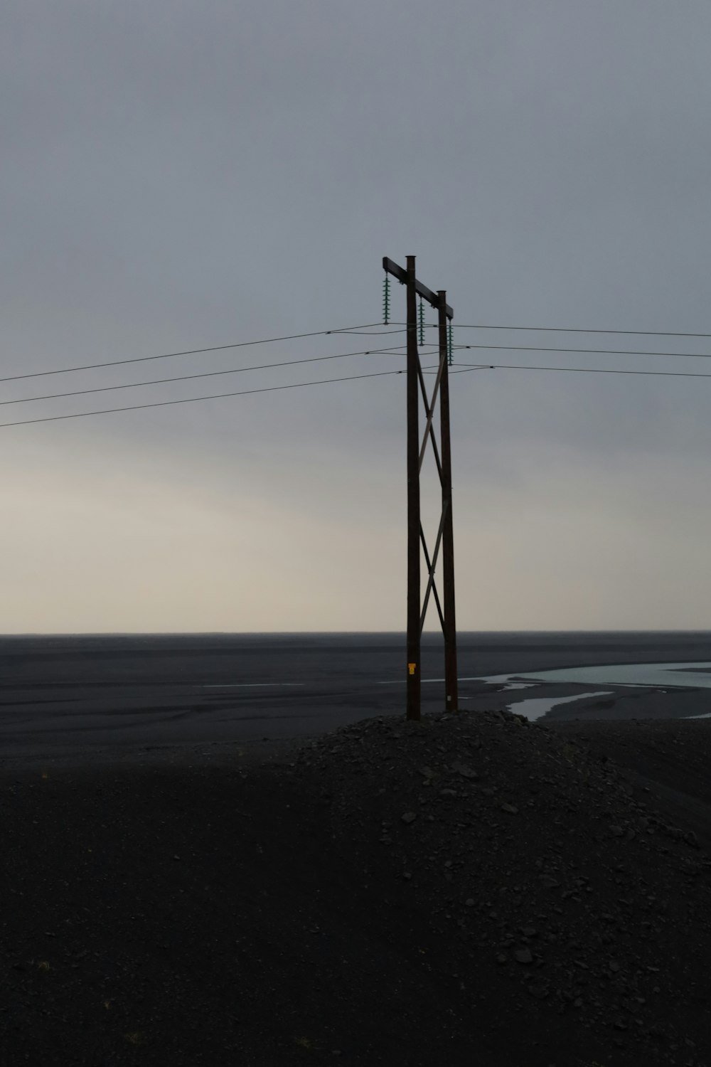 a telephone pole sitting on top of a hill