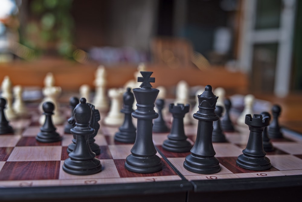 a close up of a chess board with pieces on it