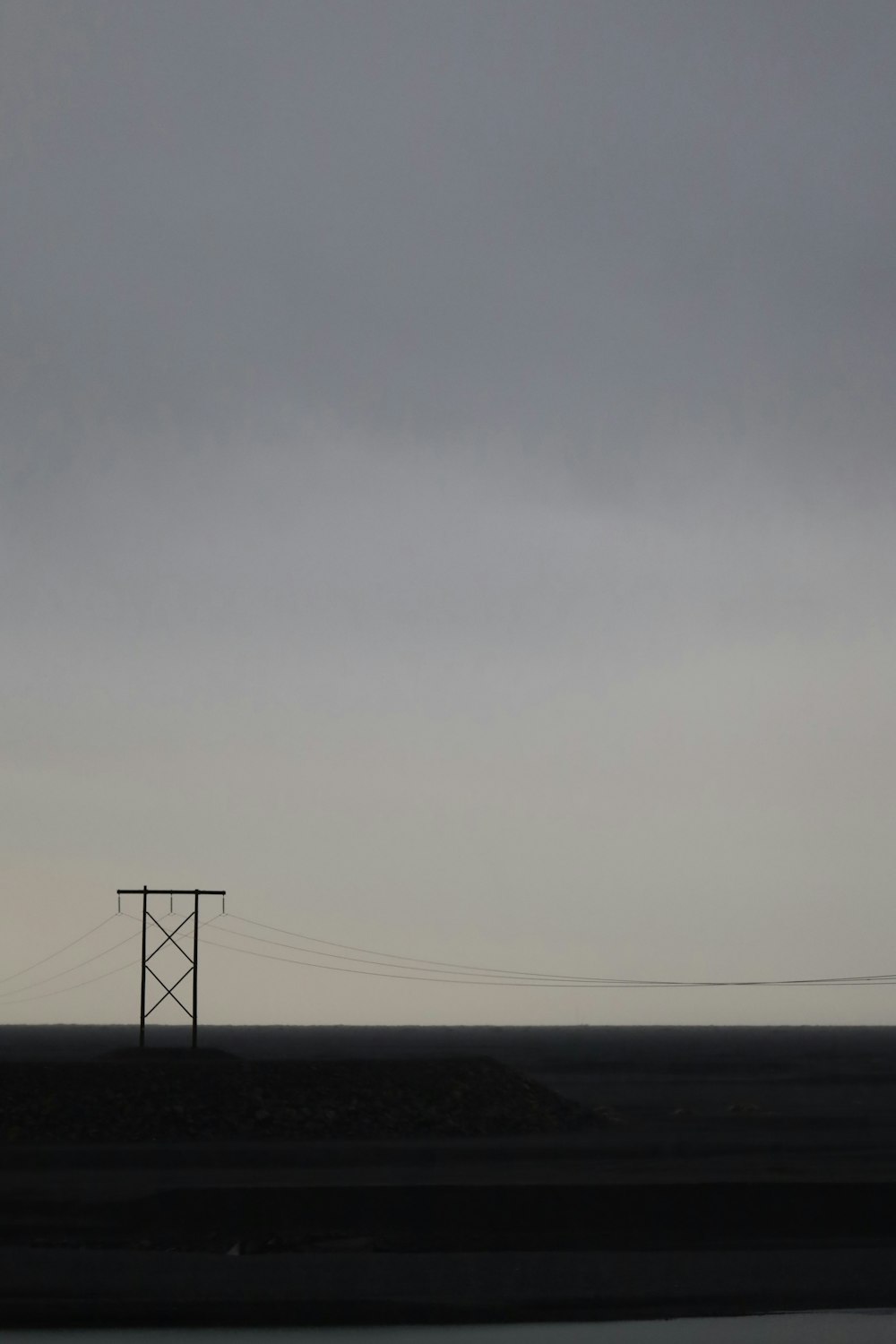 a power line in the distance under a cloudy sky