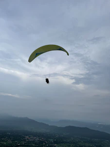 A paramotor pilot soaring above diverse landscapes, capturing breathtaking aerial views.