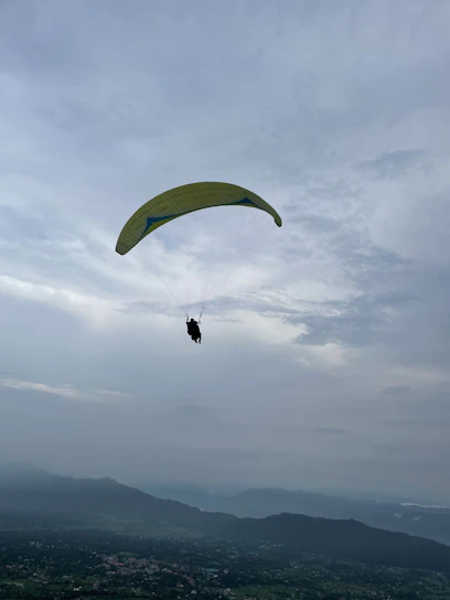 A paramotor pilot soaring above diverse landscapes, capturing breathtaking aerial views.