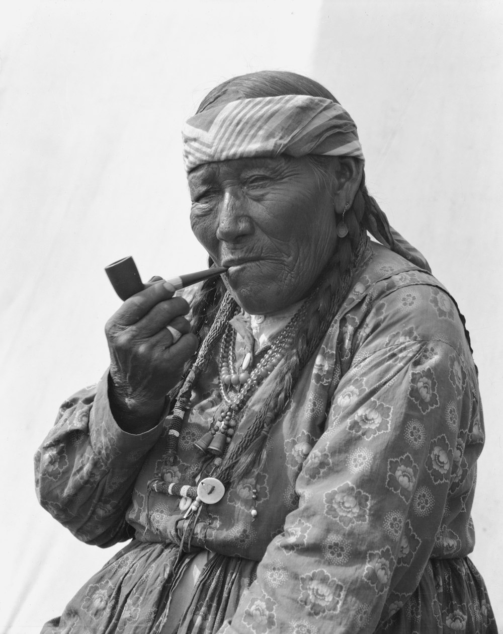 an old photo of a woman smoking a cigarette