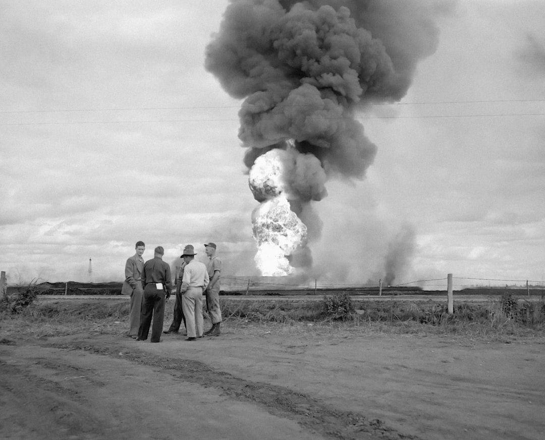 a group of men standing in front of a large cloud of smoke