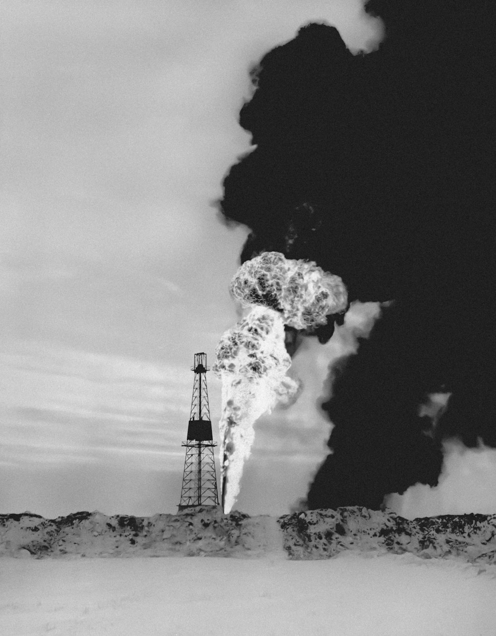 a black and white photo of smoke coming out of a pipe