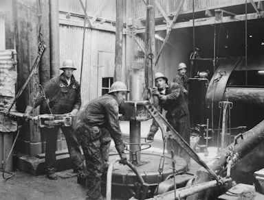 Team of engineers collaborating on an industrial project in a modern facility.