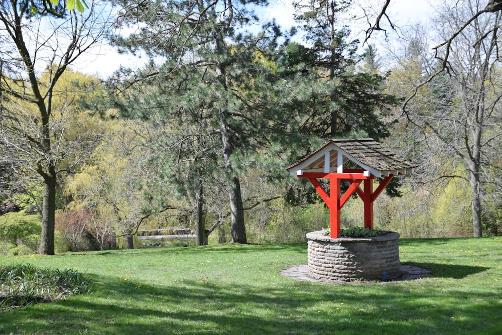 a gazebo in the middle of a grassy field