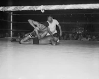 The referee counting pinfall as the audience holds their breath in anticipation.