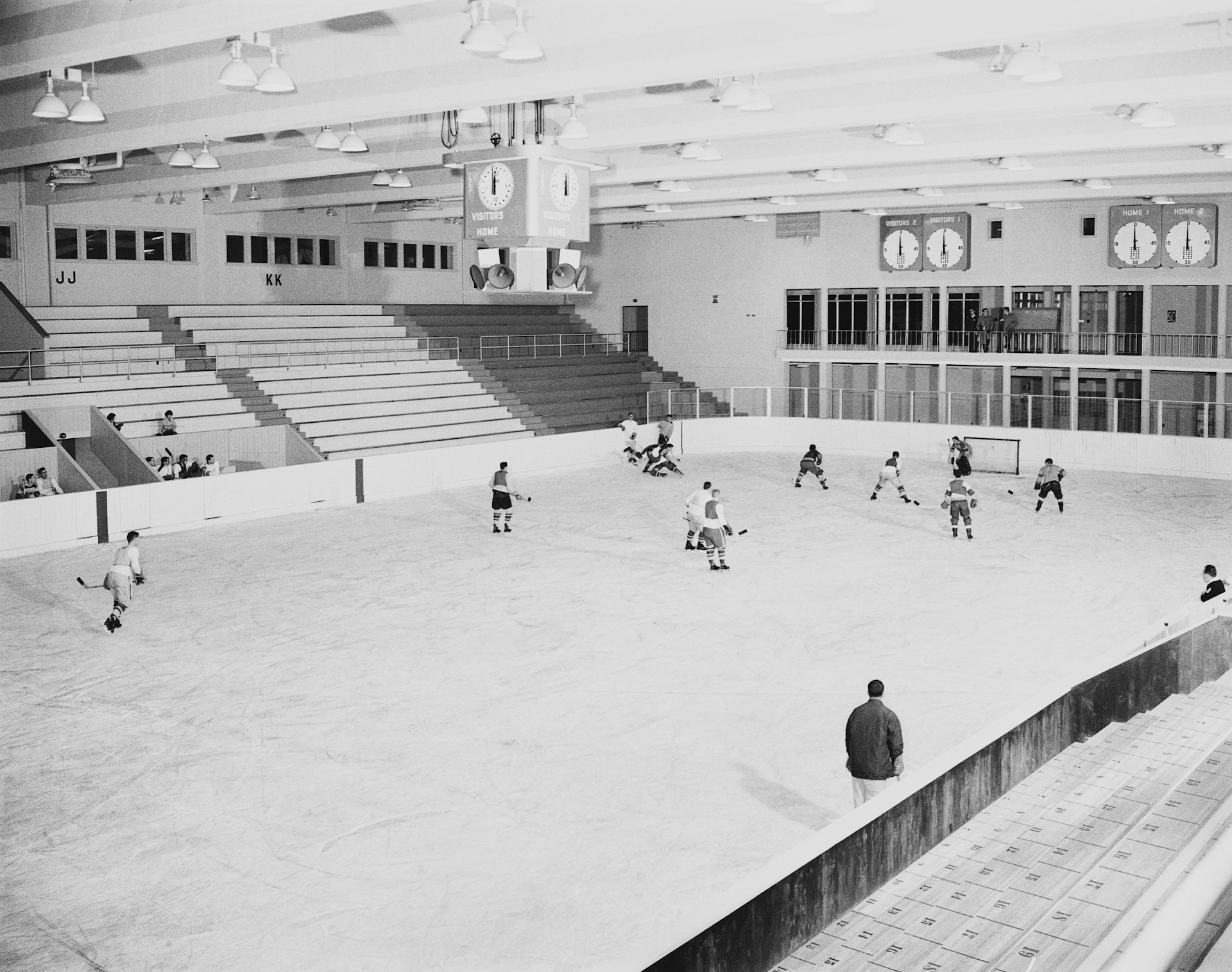 a group of people playing a game of ice hockey