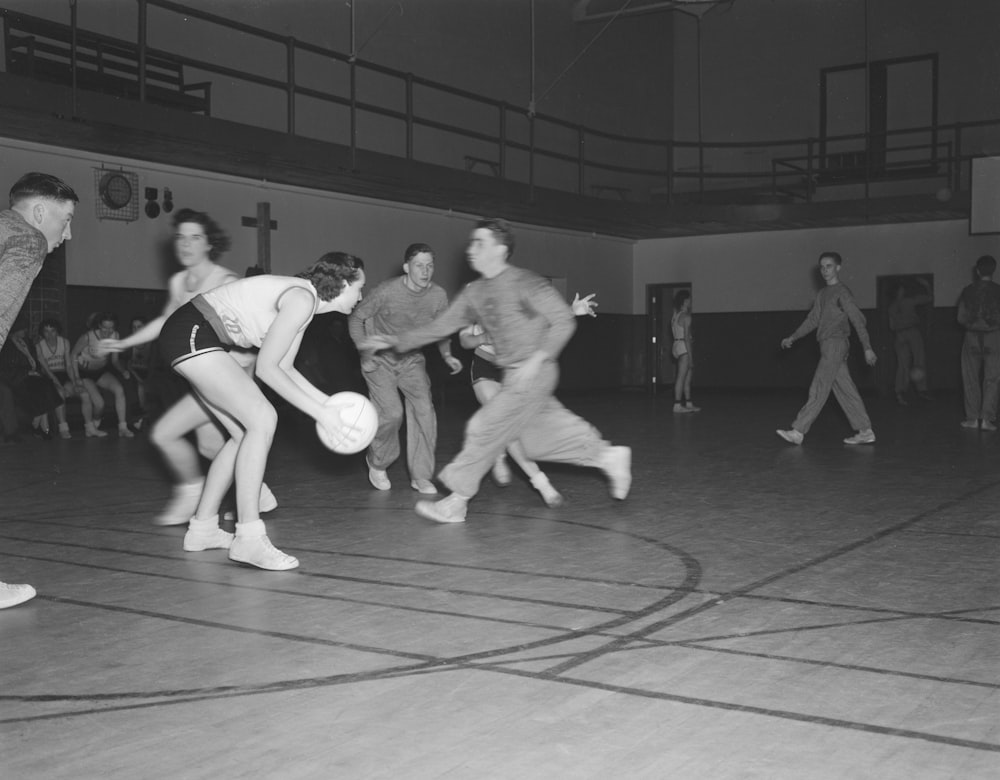 a group of people playing a game of basketball