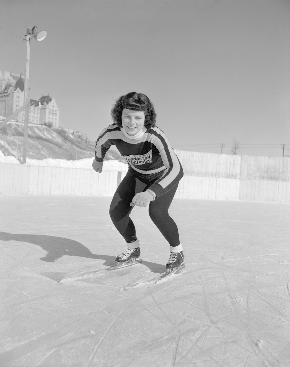 a woman riding skis down a snow covered slope