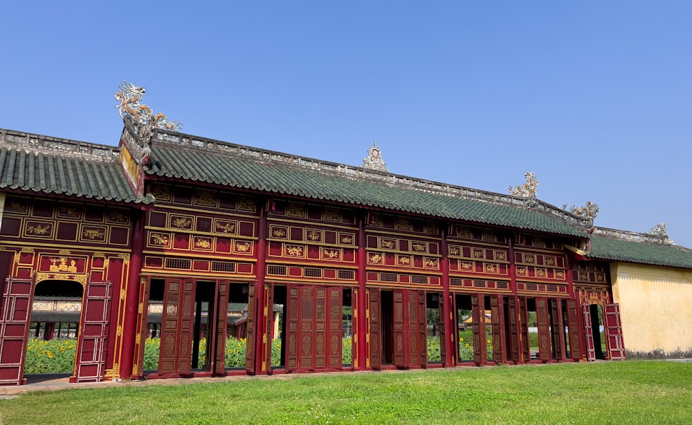 a large building with a green lawn in front of it