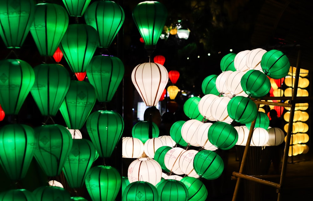 a bunch of green and white paper lanterns