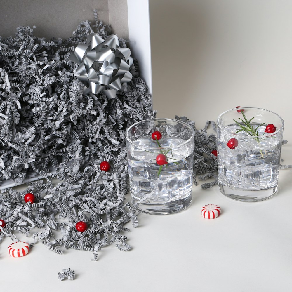 a christmas scene with a silver bow and two glasses of water