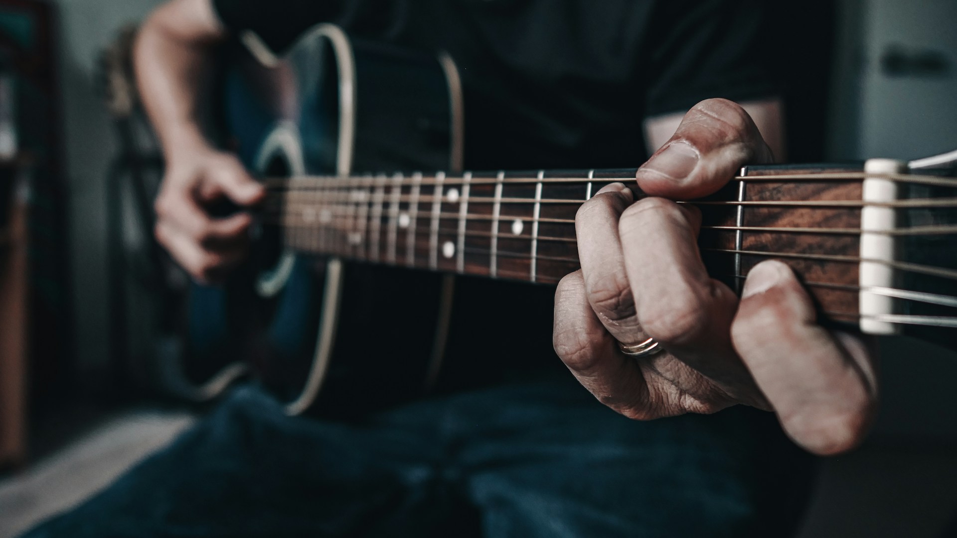 a person playing a guitar in a room