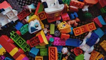 a pile of colorful legos sitting on top of a carpet