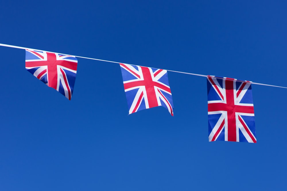 three british flags hanging on a clothes line