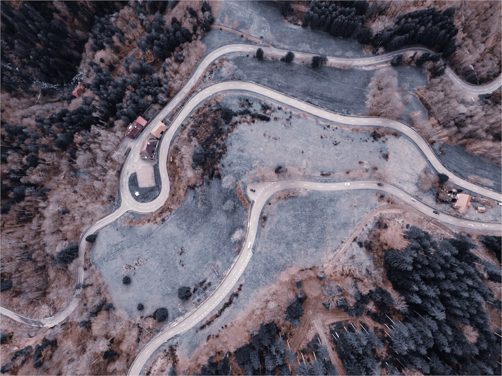 an aerial view of a winding road in the mountains